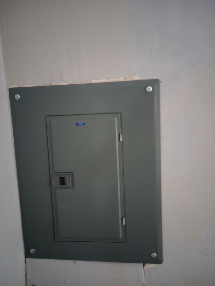 A new electrical panel installed flush in a wall