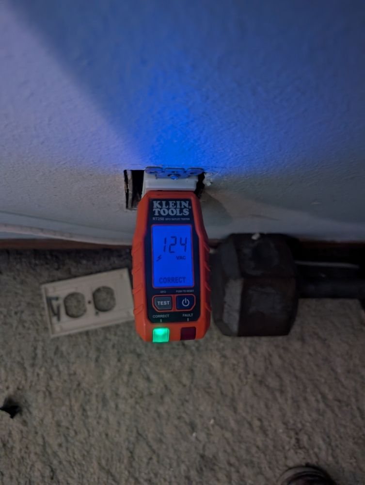 A circuit tester plugged into an outlet during troubleshooting