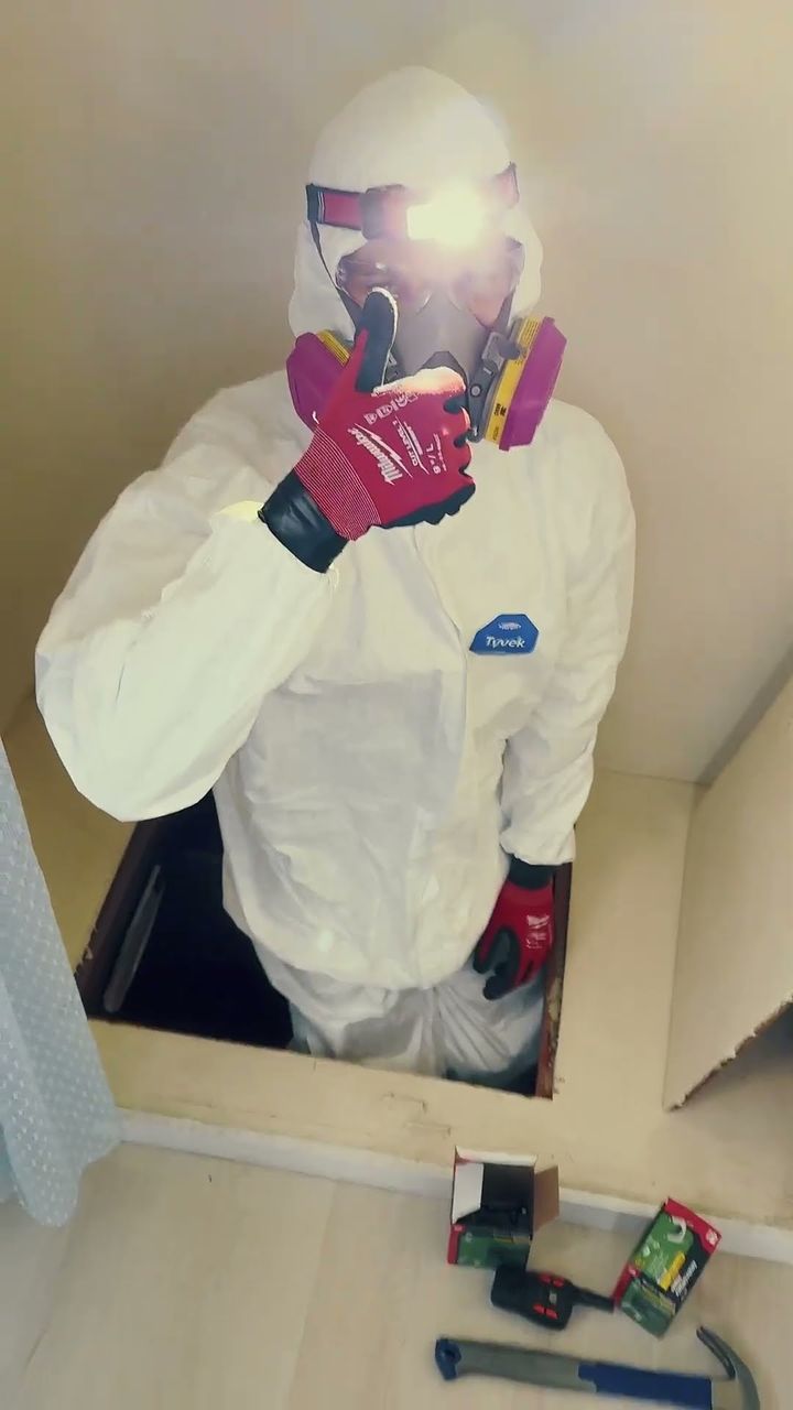 Running wire in the attic in protective gear